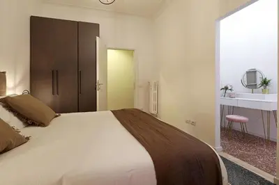 a bedroom with a large white bed and a mirror at Bologna Garden House in Rome