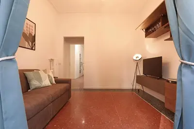 a living room with a couch and a television at Bologna Garden House in Rome