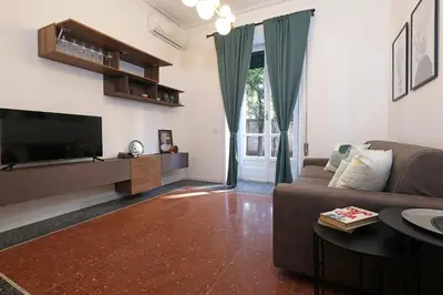 a living room with a couch and a flat screen tv at Bologna Garden House in Rome