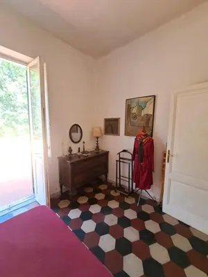 a room with a bedroom with a bed and a dresser at Terrazza Trastevere Apartment in Rome