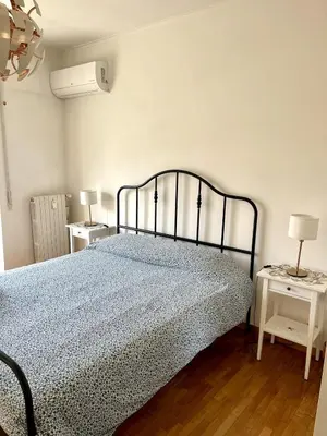 a bedroom with a bed and two night stands at La Casa di Valentina in Rome