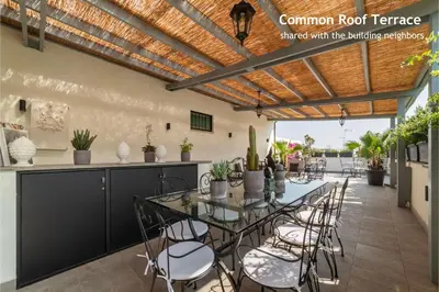 a dining room with a table and chairs on a patio at Castro Pretorio 9 - FromHometoRome in Rome