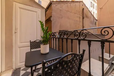 a black table with a plant on a balcony at Castro Pretorio 9 - FromHometoRome in Rome