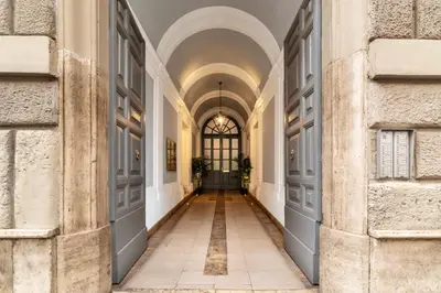 a hallway of a building with a door and a window at Castro Pretorio 9 - FromHometoRome in Rome