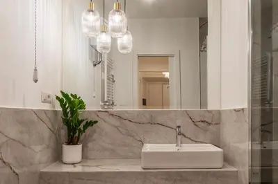 a bathroom with a sink and a mirror at Castro Pretorio 9 - FromHometoRome in Rome