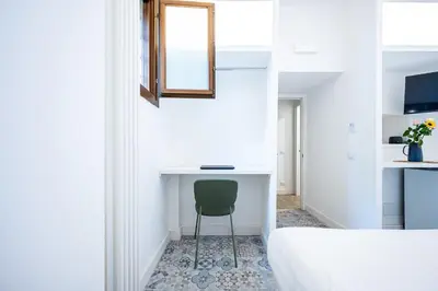 a bedroom with a desk and a chair next to a bed at Domus Piramide in Rome