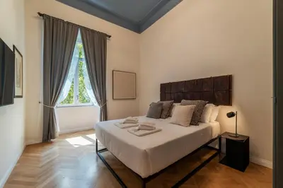 a bedroom with a large bed and a window at Castro Pretorio 21 - FromHometoRome in Rome