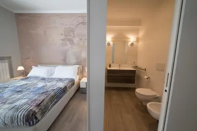 a bedroom with a bed and a toilet and a sink at VaticanRhome II in Rome