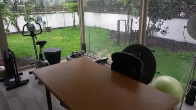 an office with a desk and a view of a yard at Bilocale EUR Grotta Perfetta 50mq casa 32mq sala hobbies e 250mq giardino in Rome