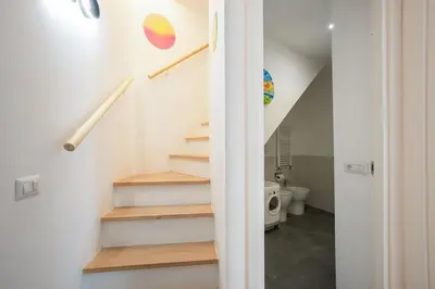 a staircase in a room with a toilet at Cottage with Garden and Terrace near Termini in Rome