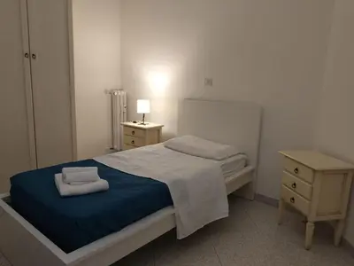 a bedroom with a bed with two towels on it at Trionfale Guest House in Rome