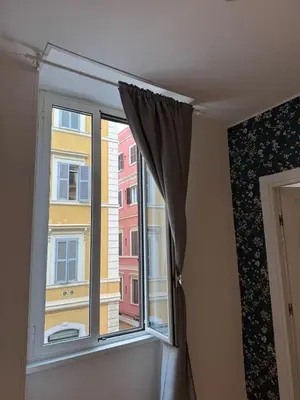 a window with a view of a building at NOI Luxury rooms Colosseum in Rome