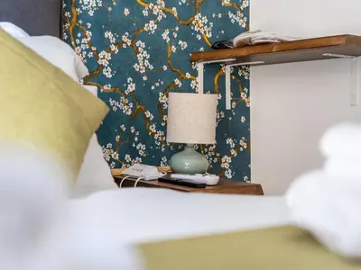 a bedroom with a bed with a lamp on a nightstand at NOI Luxury rooms Colosseum in Rome