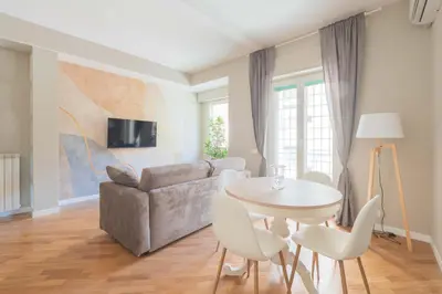 a living room with a table and a couch at SuityRHome San Giovanni 11 in Rome