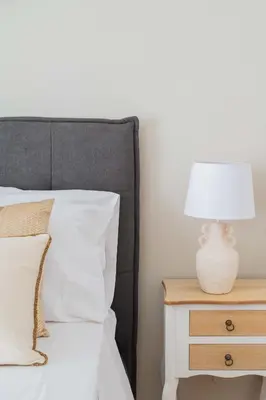 a bedroom with a bed with a lamp on a nightstand at SuityRHome San Giovanni 11 in Rome