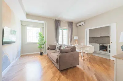 a living room with a couch and a table at SuityRHome San Giovanni 11 in Rome