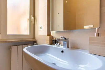 a bathroom with a white sink and a mirror at Elegantis Josephine Suite - Elegance near Spanish Steps Trevi and Pantheon in Rome
