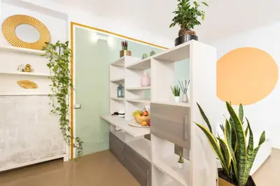 a room with white shelves and potted plants at Secret Garden Apt Colosseo - Homkeey Apartments in Rome