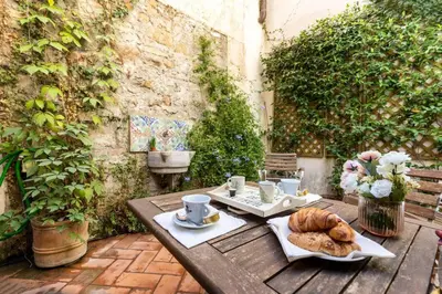 a table with a plate of bread and cups and coffee at Secret Garden Apt Colosseo - Homkeey Apartments in Rome