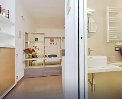 a white bathroom with a sink and a sink at Secret Garden Apt Colosseo - Homkeey Apartments in Rome