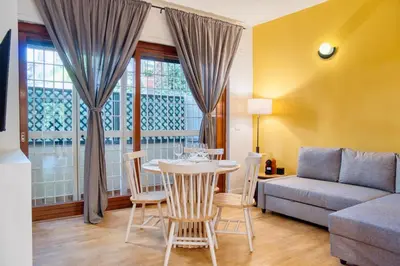 a living room with a table and a couch at Little Dome - San Pietro in Rome