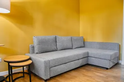 a gray couch in a room with a table and stool at Little Dome - San Pietro in Rome