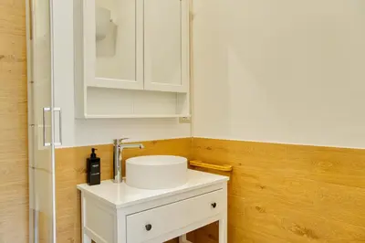 a bathroom with a white sink and white cabinets at Little Dome - San Pietro in Rome