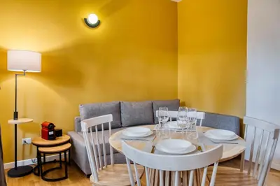 a dining room with a table and a couch at Little Dome - San Pietro in Rome