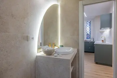 a bathroom with a sink and a counter with a mirror at Colosseum Essence - Homkeey Apartments in Rome