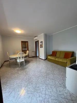 a living room with a couch and a table at Trilocale con terrazza e garage in Rome