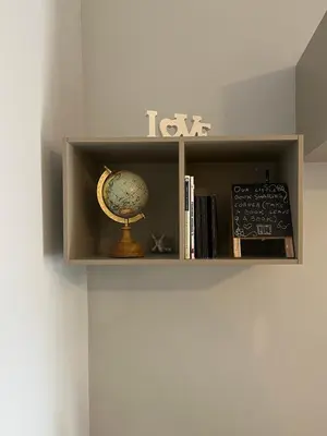 a book shelf with a globe and books on it at Trilocale con terrazza e garage in Rome