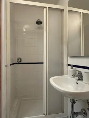 a white bathroom with a sink and a shower at incanto e campo de fiori in Rome