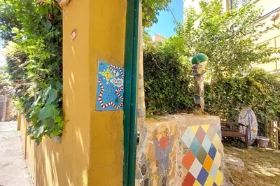 a yellow wall with colorful stickers on it at Casa Gaudì in Rome
