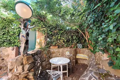 a table and chairs sitting in a garden at Casa Gaudì in Rome