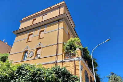 a yellow building with the number on it at Casa Gaudì in Rome