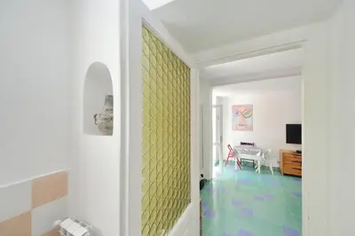 a hallway with a yellow accent wall in a house at Casa Gaudì in Rome
