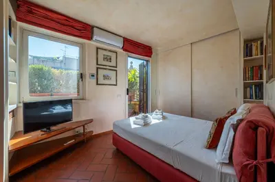 a bedroom with a bed and a flat screen tv at The Perfect View- Angel's Castle' in Rome