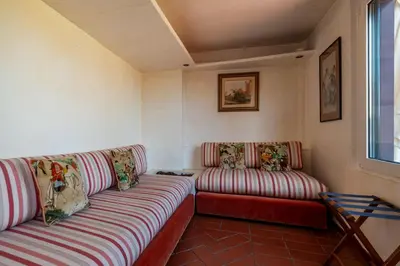 a living room with two couches and a window at The Perfect View- Angel's Castle' in Rome