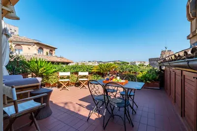 a small patio with a table and chairs on a balcony at The Perfect View- Angel's Castle' in Rome
