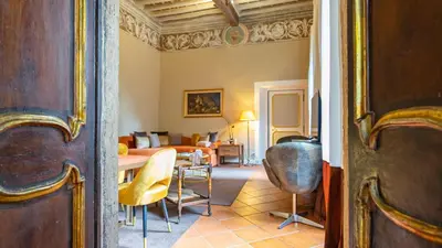 a room with a table and chairs and a living room at La Casa d'Argento in Rome