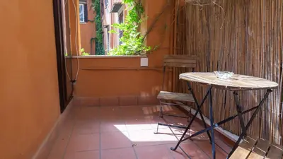 a small table and two chairs on a patio at La Casa d'Argento in Rome