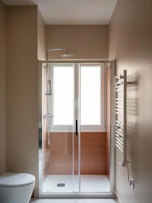 a bathroom with a shower with a toilet and a window at Zen Trastevere Luxury Room - Zen 54 in Rome