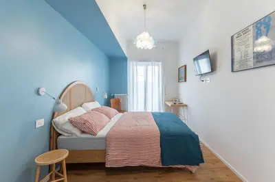a bedroom with a bed and a blue wall at Domus Veneranda in Rome
