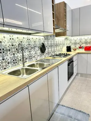 a kitchen with white cabinets and a sink at AliHouse Apartment in Rome