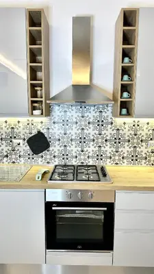 a kitchen with a stove and a hood at AliHouse Apartment in Rome