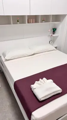 a pair of white towels sitting on a bed at AliHouse Apartment in Rome