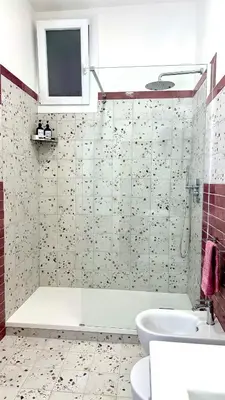 a bathroom with a shower and a tub and a sink at AliHouse Apartment in Rome