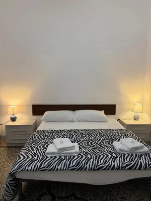 a bedroom with a bed with two towels on it at Roma Belvedere Termini in Rome