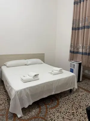 a white bed with two towels on top of it at Roma Belvedere Termini in Rome