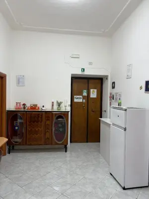 a kitchen with a refrigerator and a washer and dryer at Roma Belvedere Termini in Rome
